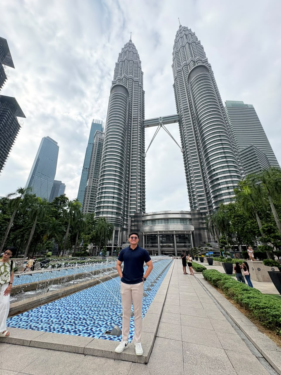 Mizan standing in front of the Petronas Twin Towers in Kuala Lumpur